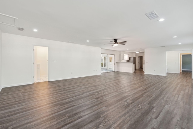 unfurnished living room featuring a ceiling fan, baseboards, visible vents, and dark wood-style floors