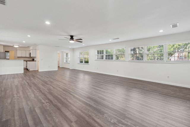 unfurnished living room with recessed lighting, a ceiling fan, dark wood-style flooring, and visible vents