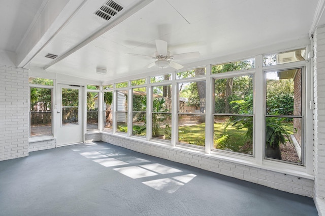 unfurnished sunroom with a ceiling fan and visible vents