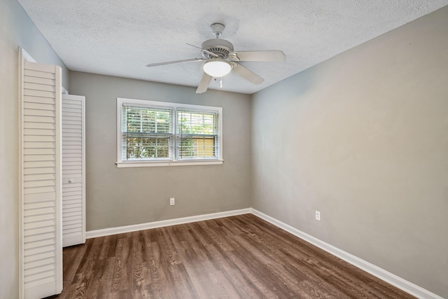 unfurnished bedroom with baseboards, a ceiling fan, a textured ceiling, and wood finished floors