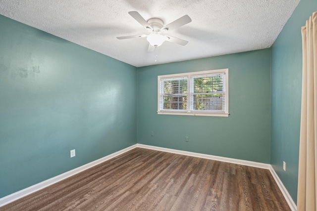 spare room with baseboards, a textured ceiling, ceiling fan, and wood finished floors
