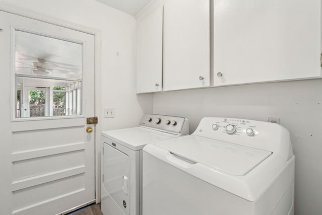 laundry area with washing machine and clothes dryer and cabinet space