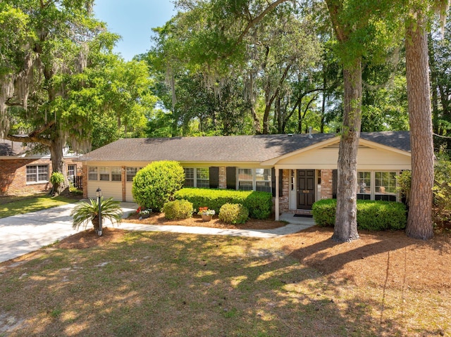 single story home with brick siding and concrete driveway
