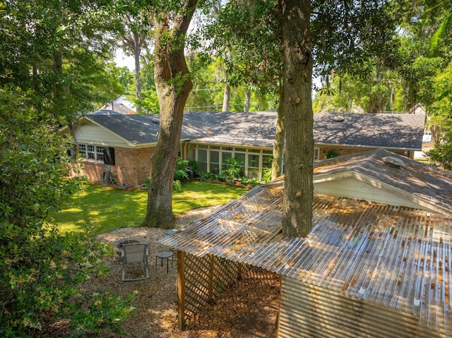 rear view of property featuring a yard