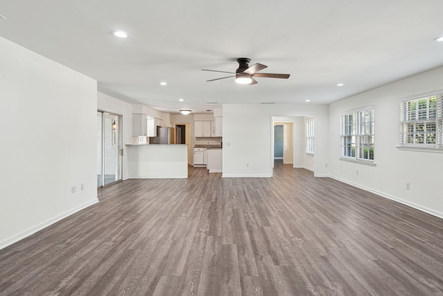 unfurnished living room featuring recessed lighting, baseboards, a ceiling fan, and dark wood-style floors