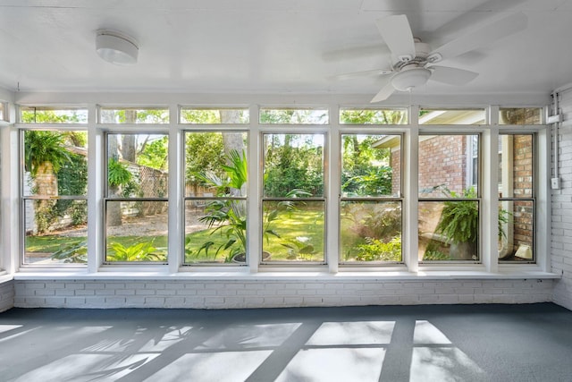 unfurnished sunroom featuring brick wall