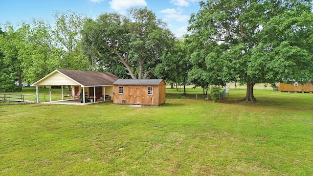449 Mary Lou Ln, Moncks Corner, SC 29461 - rear view of house featuring a carport, a storage unit, an outbuilding, fence, and a yard