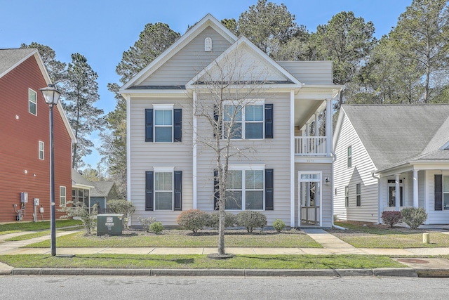 view of front of home featuring cooling unit and a balcony