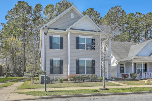view of front of house with a front lawn and central AC unit