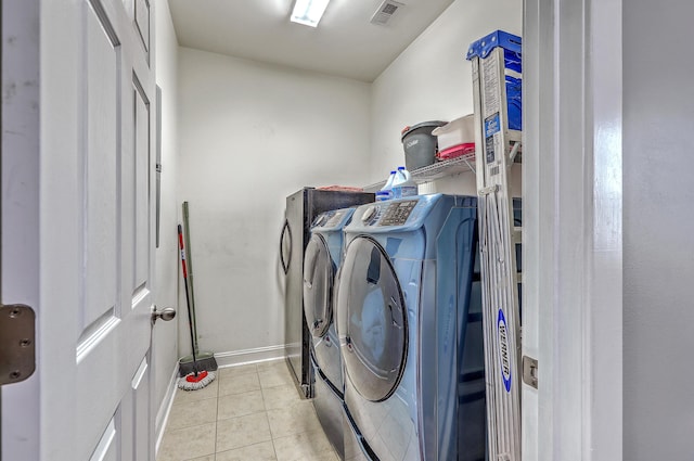 laundry area with tile patterned floors, separate washer and dryer, laundry area, baseboards, and visible vents