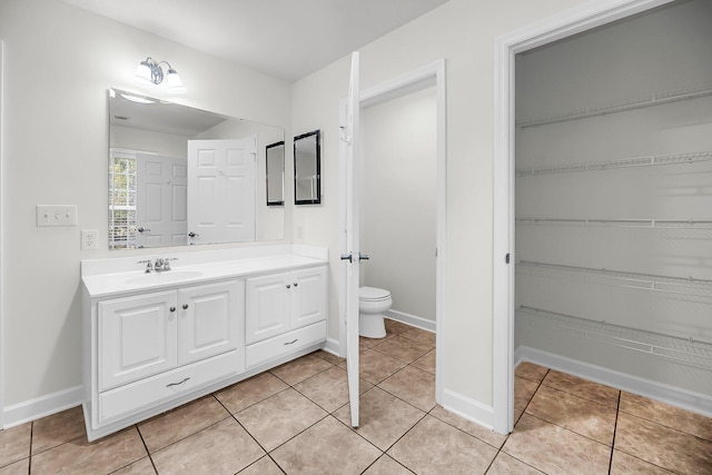 bathroom featuring tile patterned flooring, vanity, and toilet