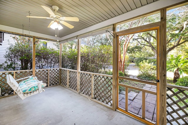 unfurnished sunroom featuring ceiling fan and wood ceiling