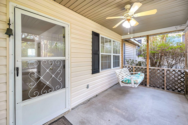 unfurnished sunroom with ceiling fan