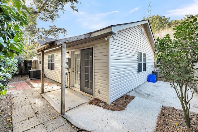 view of property exterior with a patio and central air condition unit