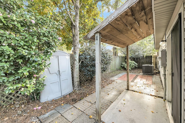 view of patio / terrace featuring a storage unit and cooling unit