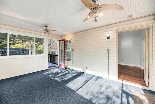 unfurnished sunroom with ceiling fan