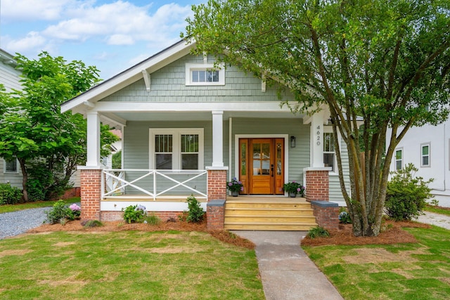 4620 Ohear Ave, North Charleston, SC 29405 - view of front of house featuring a porch, a front yard, and brick siding
