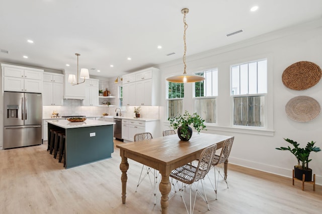 4620 Ohear Ave, North Charleston, SC 29405 - dining area with light wood finished floors, recessed lighting, baseboards, and ornamental molding