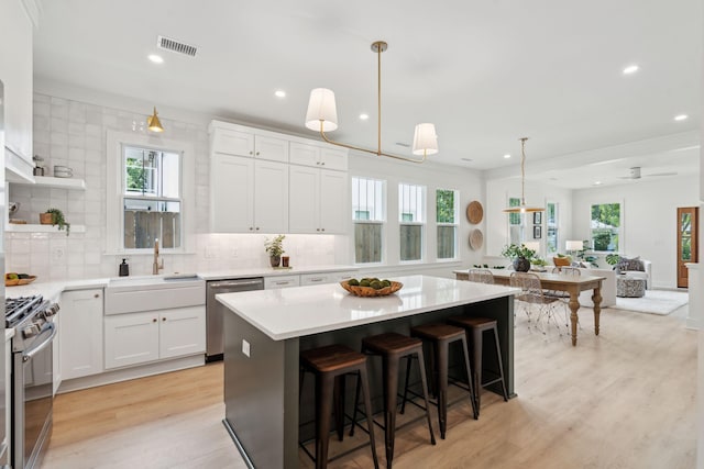 4620 Ohear Ave, North Charleston, SC 29405 - kitchen featuring appliances with stainless steel finishes, a sink, recessed lighting, light wood finished floors, and plenty of natural light