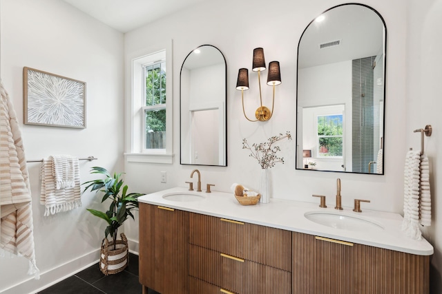 4620 Ohear Ave, North Charleston, SC 29405 - bathroom featuring healthy amount of natural light, double vanity, tile patterned flooring, and baseboards