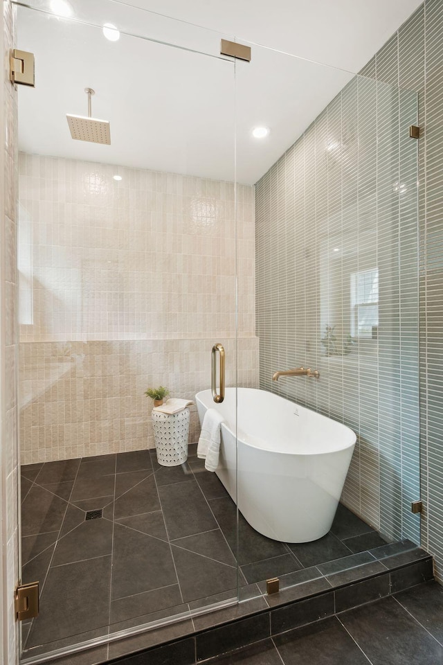 4620 Ohear Ave, North Charleston, SC 29405 - bathroom featuring tile walls, a freestanding bath, tile patterned flooring, tiled shower, and recessed lighting