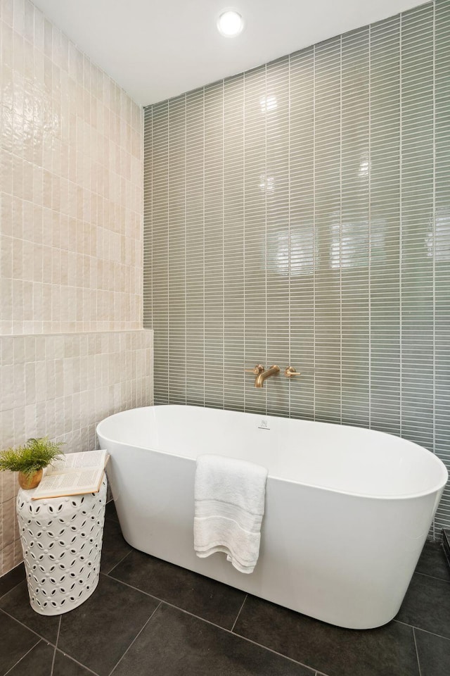 4620 Ohear Ave, North Charleston, SC 29405 - bathroom with tile walls, tile patterned floors, a soaking tub, and recessed lighting