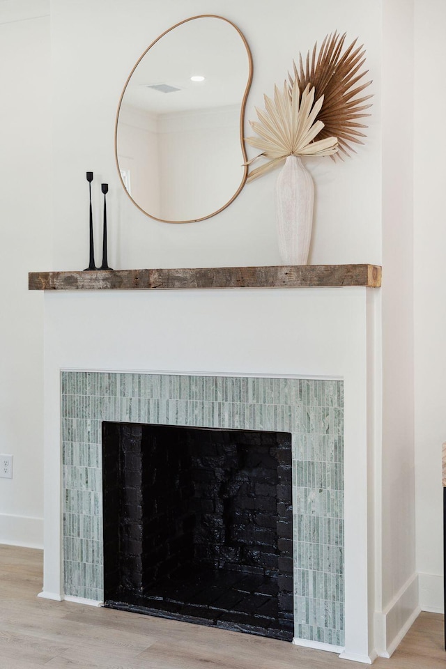 4620 Ohear Ave, North Charleston, SC 29405 - detailed view of a fireplace, wood finished floors, and baseboards