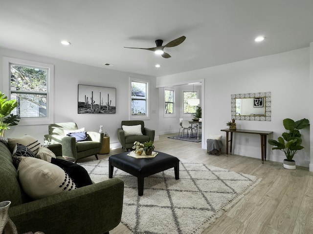 living room featuring light wood finished floors, recessed lighting, visible vents, ceiling fan, and baseboards