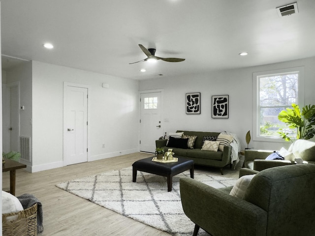 living room with recessed lighting, visible vents, plenty of natural light, and light wood finished floors