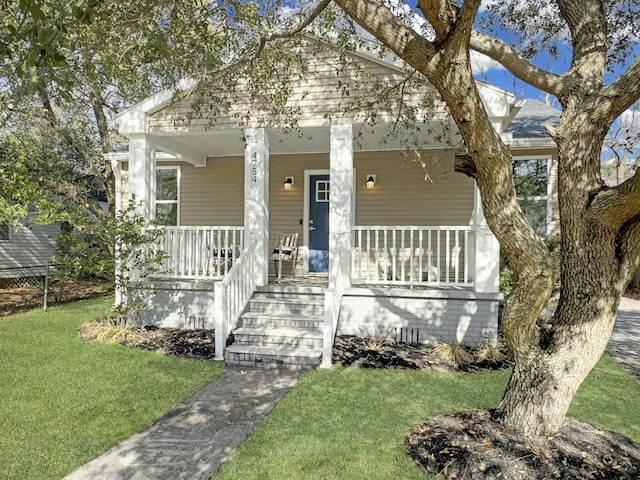 bungalow-style home featuring a porch and a front yard