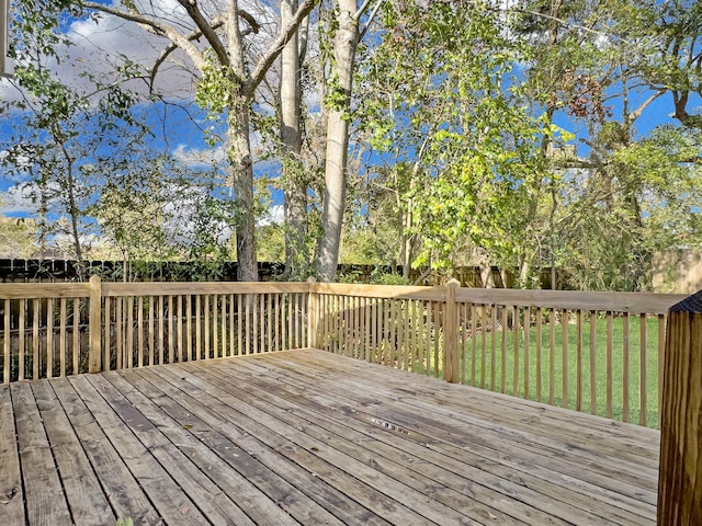 wooden terrace featuring a yard