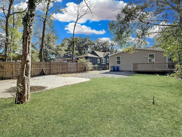 view of yard featuring a patio area, a fenced backyard, and a wooden deck