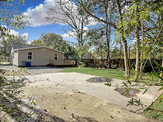 view of yard with a patio area, fence, and a wooden deck