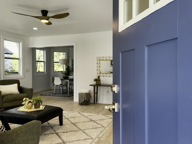 interior space with recessed lighting, light wood-type flooring, a ceiling fan, and baseboards