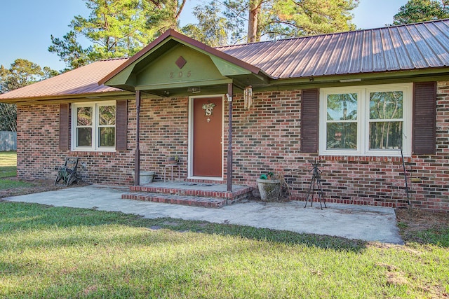 single story home with a front lawn and a patio