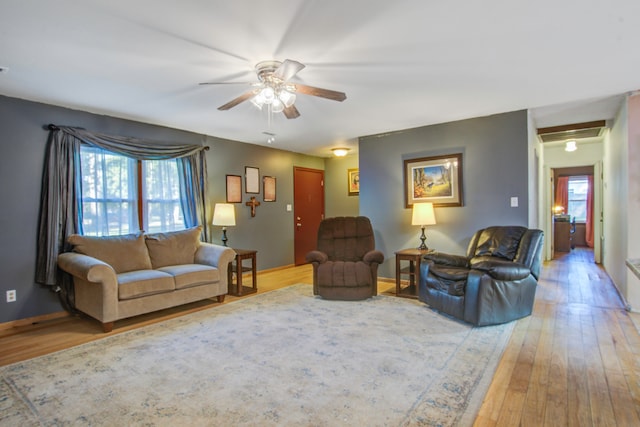 living room featuring light hardwood / wood-style floors and ceiling fan