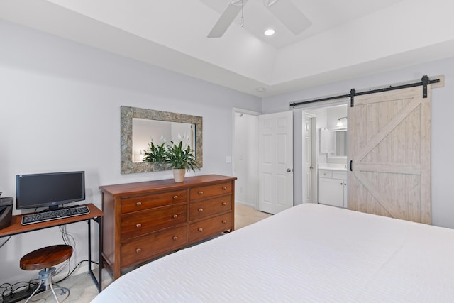 bedroom with ensuite bathroom, ceiling fan, and a barn door