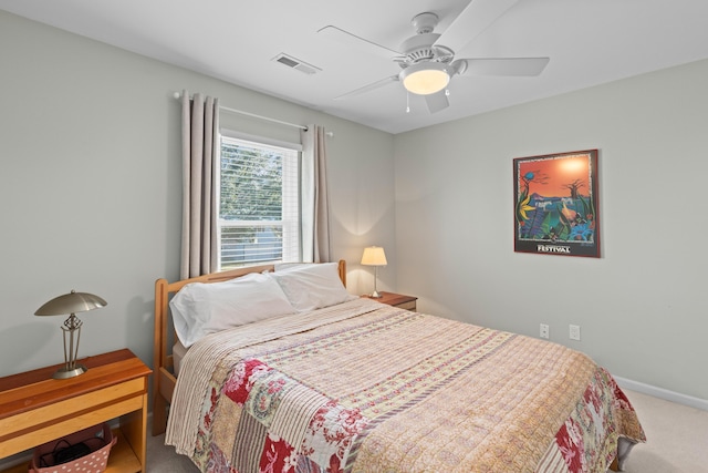 carpeted bedroom with baseboards, visible vents, and a ceiling fan