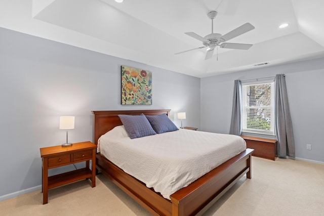 bedroom with light carpet, baseboards, visible vents, a raised ceiling, and recessed lighting