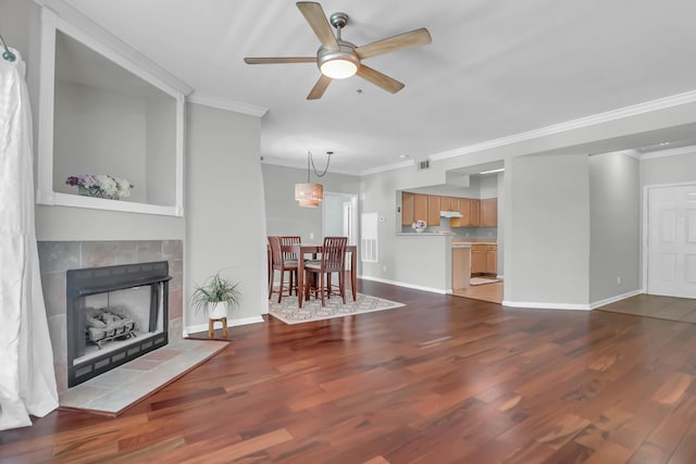 700 Daniel Ellis Dr Unit 3108, Charleston, SC 29412 - living area with crown molding, a ceiling fan, dark wood-style floors, and a tile fireplace
