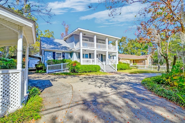 view of front of home featuring covered porch and a balcony