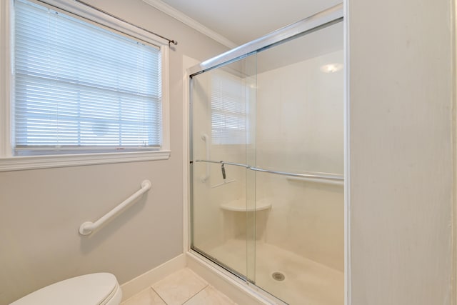 bathroom with ornamental molding, a shower with shower door, toilet, and tile patterned flooring