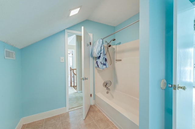 bathroom featuring lofted ceiling, bathing tub / shower combination, and tile patterned floors