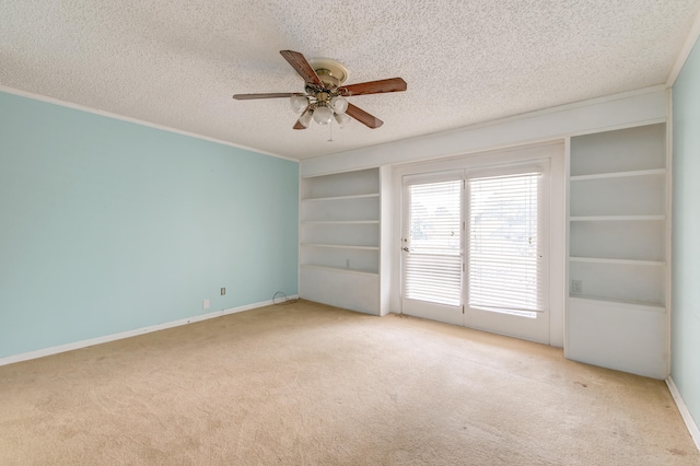 unfurnished room with ornamental molding, ceiling fan, a textured ceiling, and light colored carpet