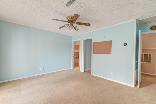 empty room with ceiling fan, a textured ceiling, and light colored carpet