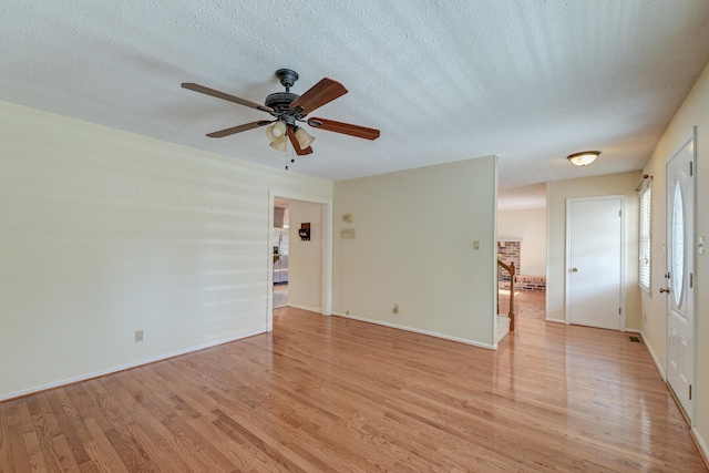 unfurnished room with light hardwood / wood-style flooring, a textured ceiling, and ceiling fan