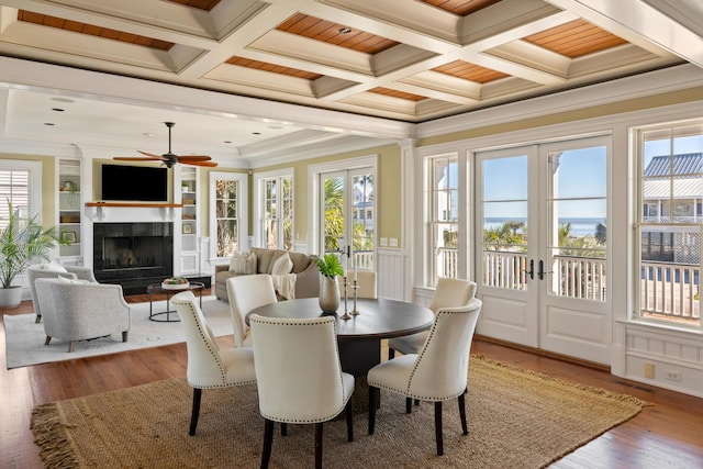 sunroom featuring visible vents, coffered ceiling, a premium fireplace, french doors, and beam ceiling