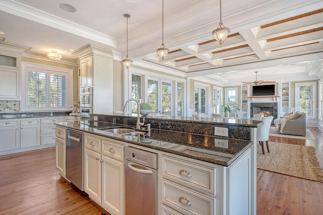 kitchen featuring plenty of natural light, open floor plan, and a sink