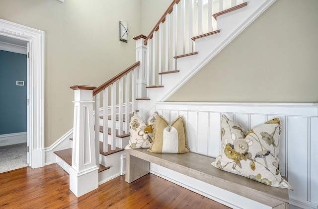 stairs with wood finished floors and baseboards