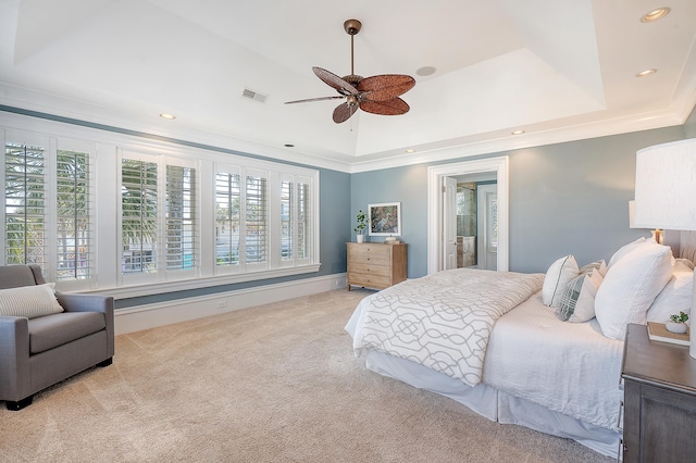 carpeted bedroom featuring ornamental molding, a tray ceiling, visible vents, and recessed lighting